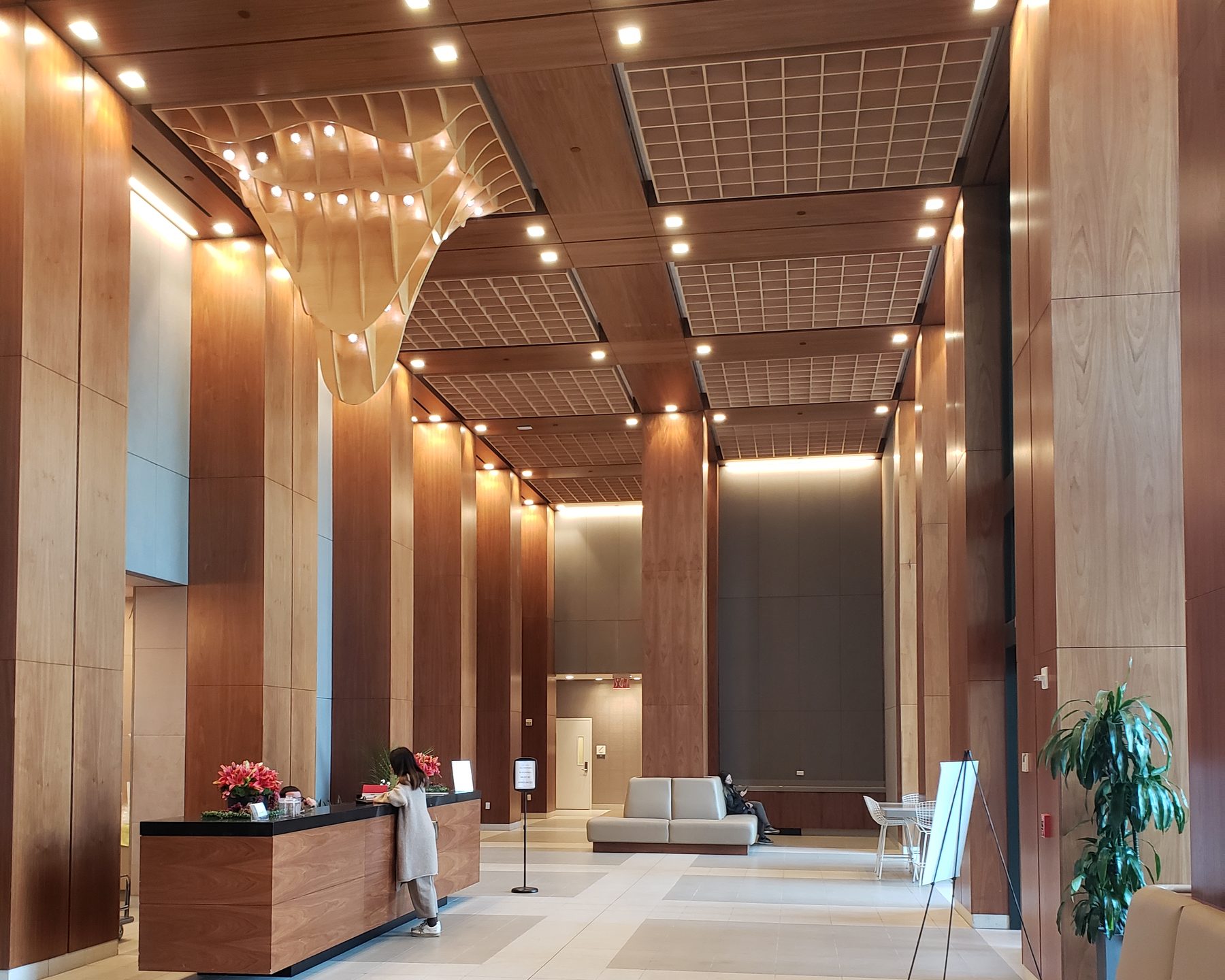 Prestige Millwork — curved wood ceiling feature and reception desk in the 485 Marin lobby, Jersey City